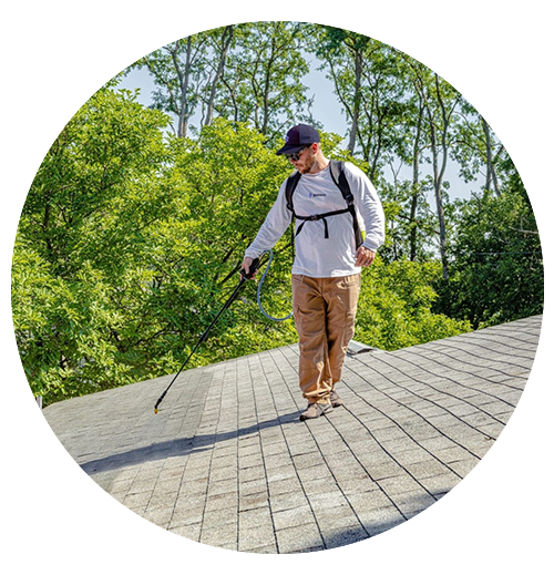 Circular cropped photo of technician working on exterior surface of residential property