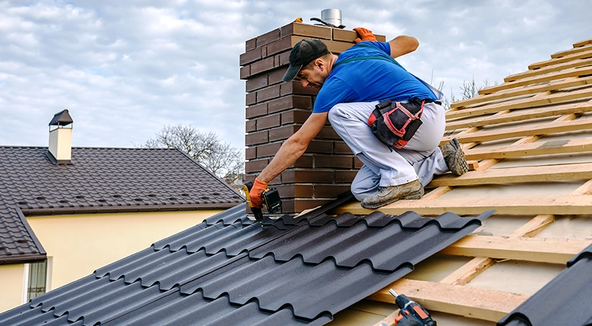 Worker Installing Shingles on a Residential Roof Replacement